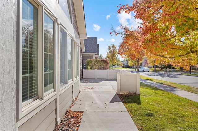 view of side of home with a lawn