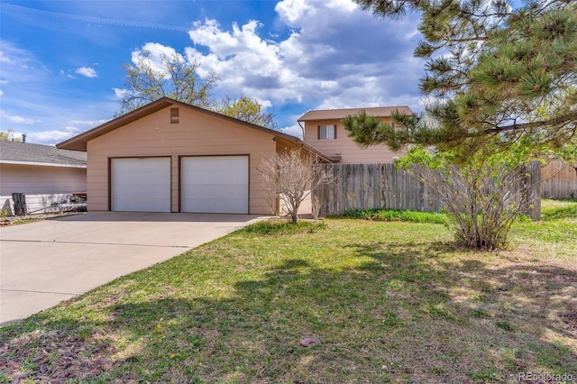 view of front of property with a garage, a front lawn, and an outbuilding