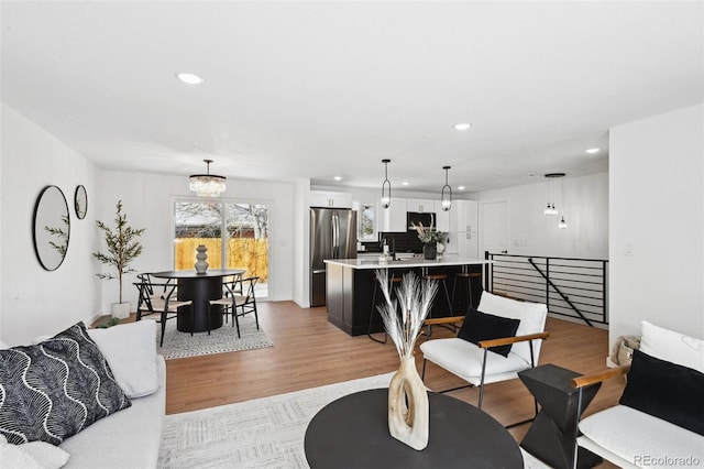 290 Beryl Way, Broomfield, CO 80020 - living room featuring recessed lighting, light wood-style flooring, and a chandelier