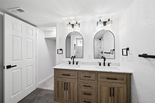 290 Beryl Way, Broomfield, CO 80020 - full bathroom with a textured ceiling, double vanity, a textured wall, and baseboards
