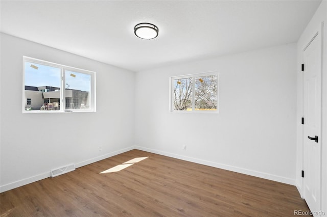 290 Beryl Way, Broomfield, CO 80020 - unfurnished bedroom with multiple windows, baseboards, and wood finished floors