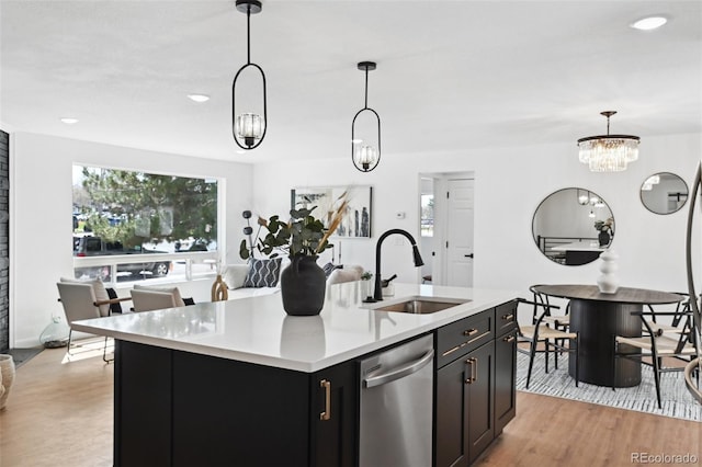 290 Beryl Way, Broomfield, CO 80020 - kitchen with stainless steel dishwasher, a sink, light countertops, hanging light fixtures, and recessed lighting