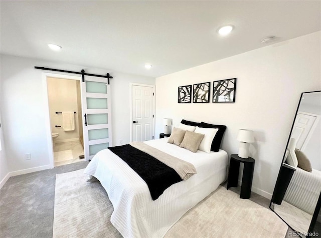 290 Beryl Way, Broomfield, CO 80020 - bedroom featuring a barn door, light carpet, baseboards, recessed lighting, and connected bathroom