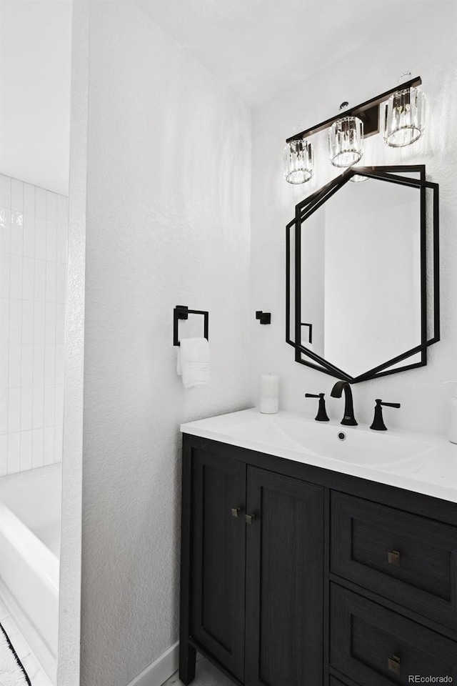 290 Beryl Way, Broomfield, CO 80020 - full bath with a chandelier, vanity, a tub, and baseboards