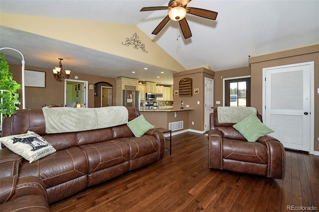 living area featuring ceiling fan with notable chandelier, dark wood-style flooring, visible vents, and baseboards