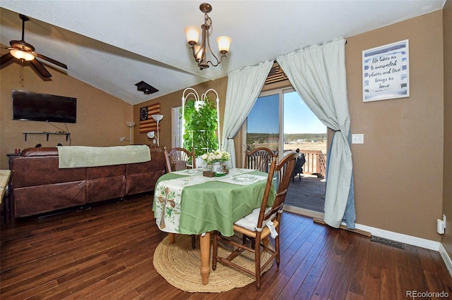 dining area with baseboards, visible vents, dark wood finished floors, vaulted ceiling, and ceiling fan with notable chandelier