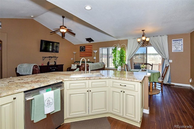 kitchen featuring dishwasher, cream cabinetry, open floor plan, and a sink