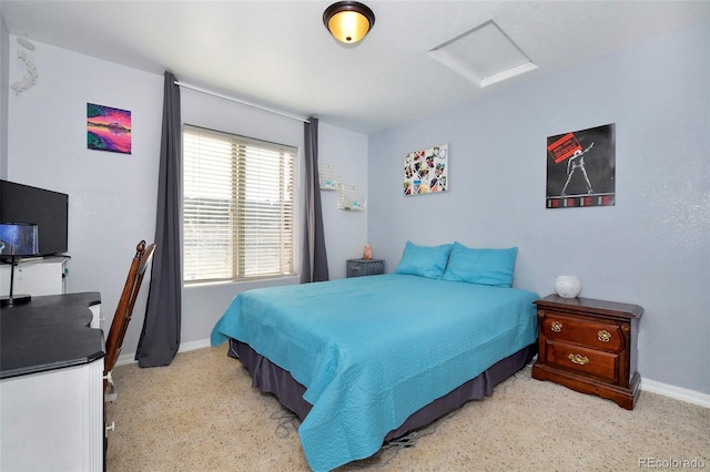 bedroom with attic access and baseboards