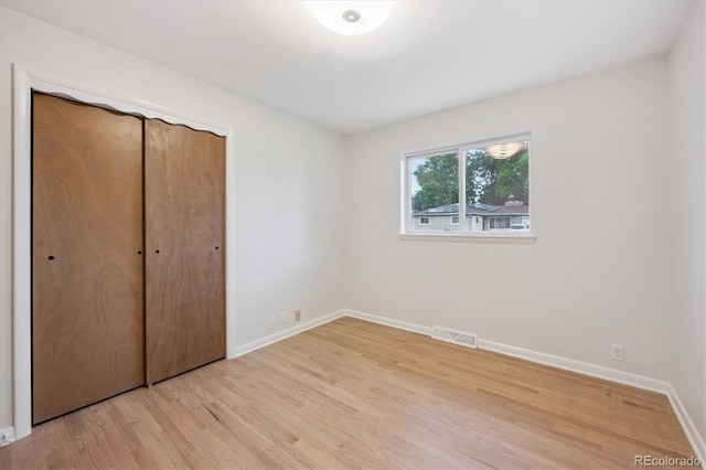3384 W Arlington Ave, Littleton, CO 80123 - unfurnished bedroom featuring light wood finished floors and a closet