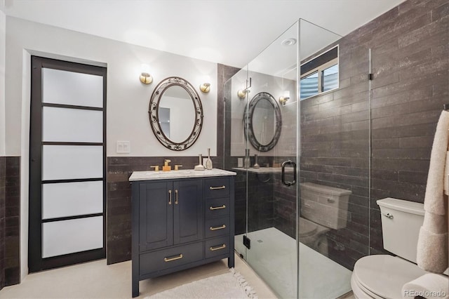 3384 W Arlington Ave, Littleton, CO 80123 - bathroom featuring tile walls, vanity, a stall shower, and a wainscoted wall