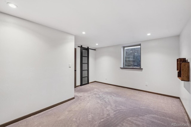 3384 W Arlington Ave, Littleton, CO 80123 - spare room with a barn door, carpet, and recessed lighting
