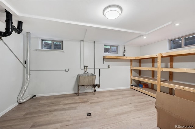 3384 W Arlington Ave, Littleton, CO 80123 - basement featuring light wood finished floors, recessed lighting, and plenty of natural light