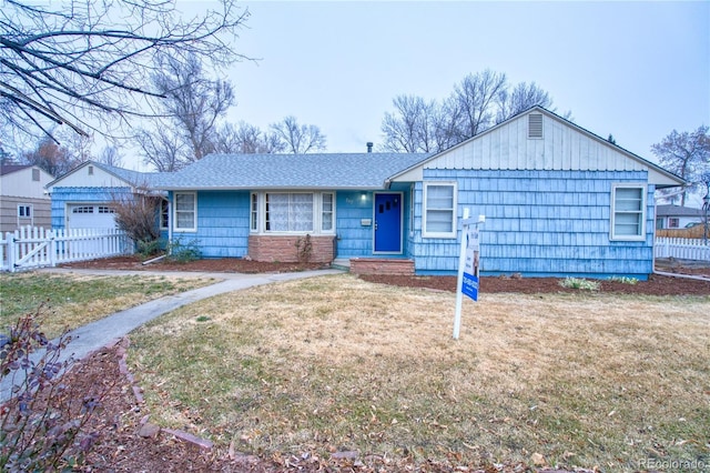 single story home with a garage and a front yard