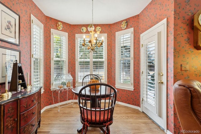 dining area featuring light hardwood / wood-style flooring and an inviting chandelier