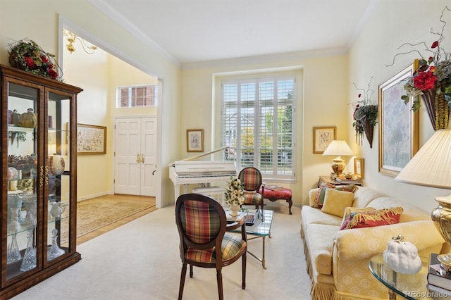 living area with crown molding and light colored carpet