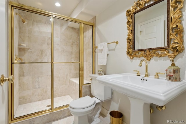 bathroom with toilet, tile patterned floors, sink, and an enclosed shower