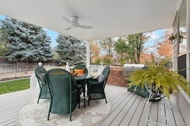 wooden terrace with area for grilling and ceiling fan