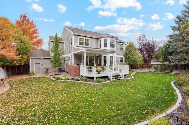 back of property featuring central AC, a deck, and a lawn