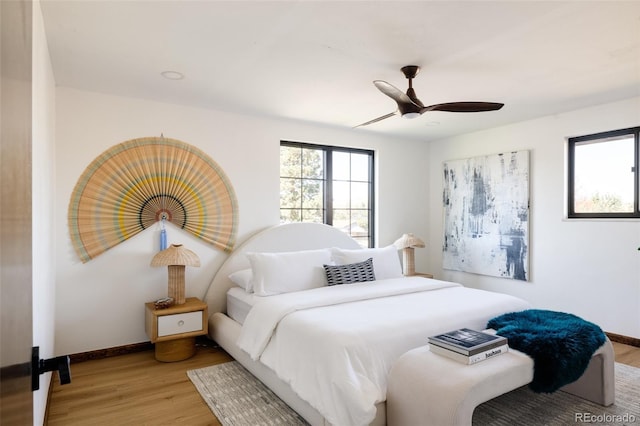 bedroom with ceiling fan and light wood-type flooring