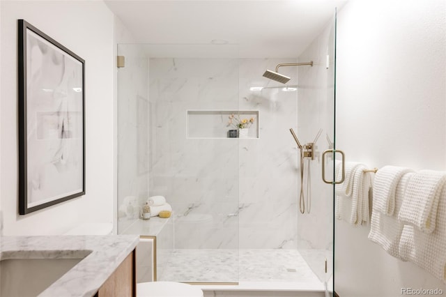 bathroom featuring vanity and an enclosed shower