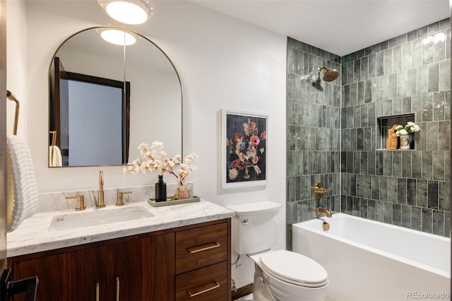 full bathroom featuring vanity, toilet, and tiled shower / bath