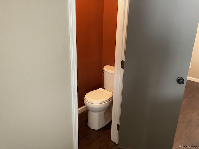 bathroom with toilet and wood-type flooring