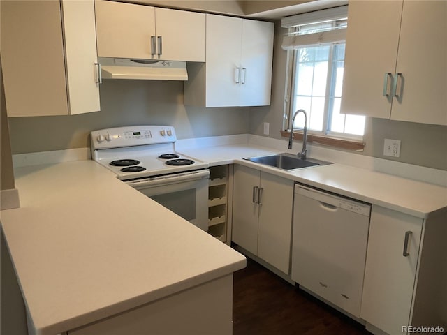 kitchen featuring dark wood-type flooring, white appliances, sink, and white cabinets