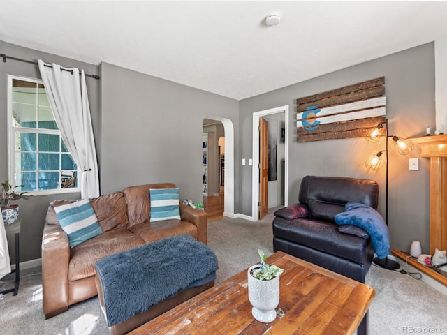 4540 Yarrow St, Wheat Ridge, CO 80033 - carpeted living area featuring arched walkways and baseboards