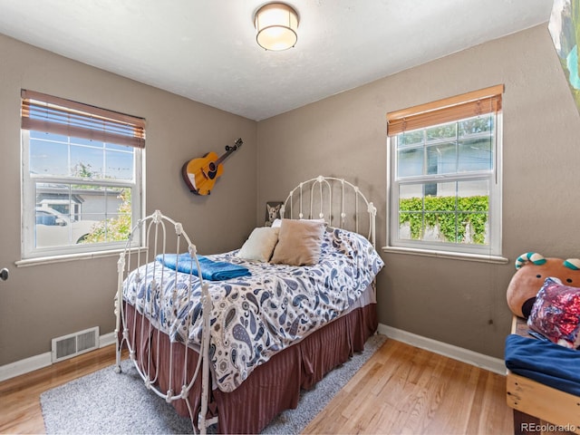 4540 Yarrow St, Wheat Ridge, CO 80033 - bedroom featuring wood finished floors and multiple windows
