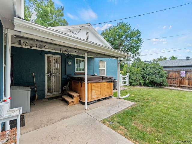 4540 Yarrow St, Wheat Ridge, CO 80033 - view of exterior entry featuring a hot tub and a patio