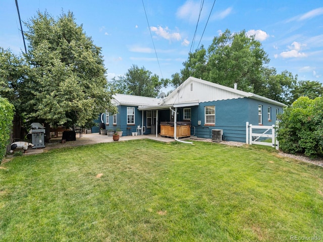 4540 Yarrow St, Wheat Ridge, CO 80033 - back of property featuring a hot tub and a patio