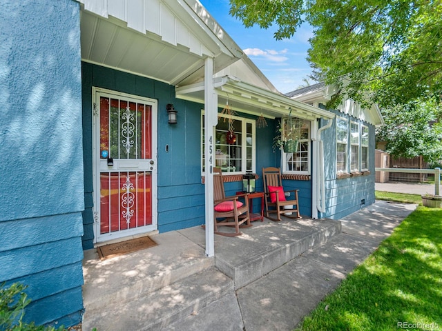 4540 Yarrow St, Wheat Ridge, CO 80033 - doorway to property featuring covered porch