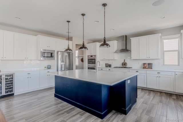 16383 Ute Peak Way, Broomfield, CO 80023 - kitchen with stainless steel appliances, wall chimney range hood, wine cooler, backsplash, and light countertops
