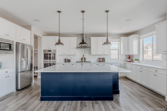 16383 Ute Peak Way, Broomfield, CO 80023 - kitchen featuring stainless steel appliances, an island with sink, backsplash, and light countertops