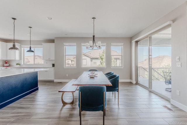 16383 Ute Peak Way, Broomfield, CO 80023 - dining area featuring a chandelier, light wood-style flooring, and recessed lighting