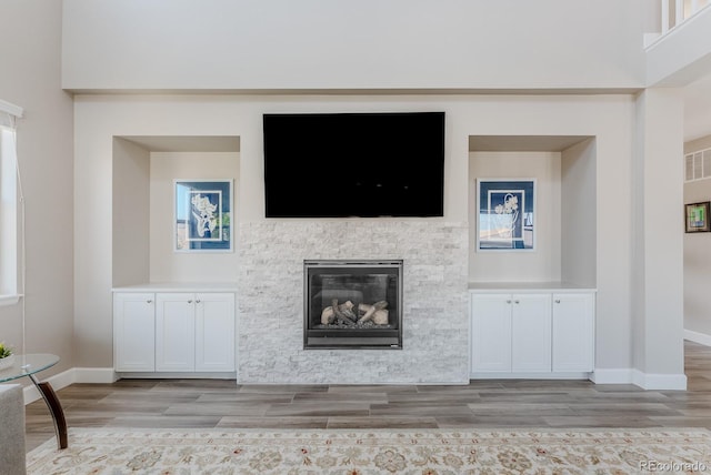 16383 Ute Peak Way, Broomfield, CO 80023 - unfurnished living room featuring light wood-style flooring and a stone fireplace