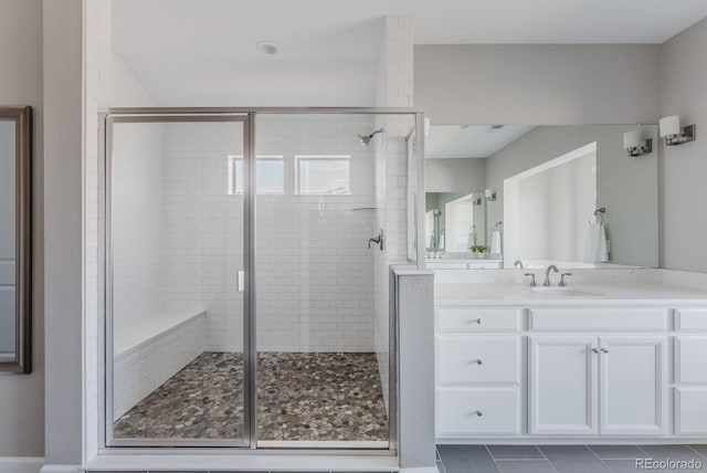 16383 Ute Peak Way, Broomfield, CO 80023 - bathroom featuring a shower stall, vanity, and tile patterned flooring