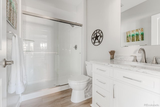 16383 Ute Peak Way, Broomfield, CO 80023 - full bathroom featuring vanity, a stall shower, and wood finished floors