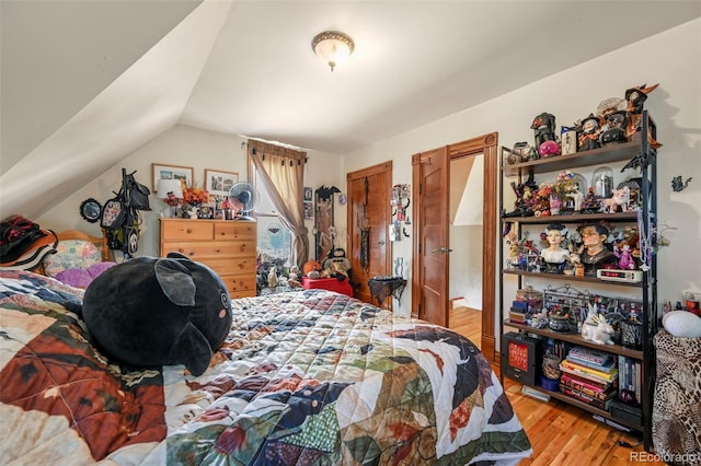 bedroom with light hardwood / wood-style flooring and vaulted ceiling