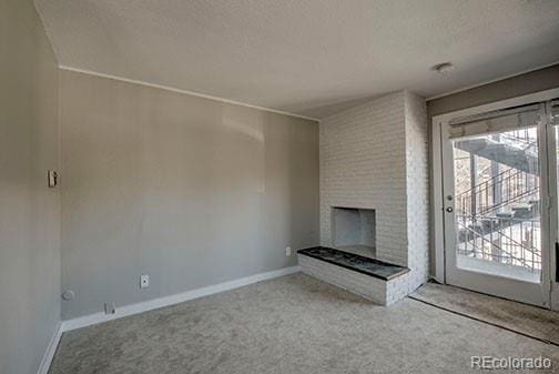 214 N Main St Unit 14, Breckenridge, CO 80424 - unfurnished living room featuring carpet, a fireplace, baseboards, and a textured ceiling