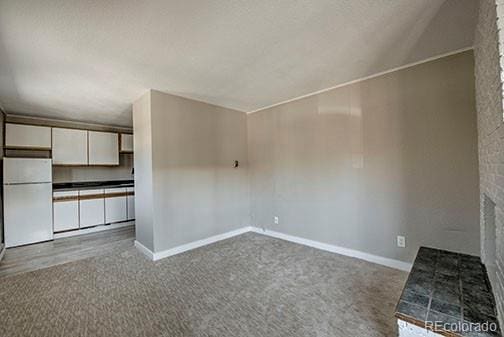 214 N Main St Unit 14, Breckenridge, CO 80424 - unfurnished living room with dark carpet and baseboards