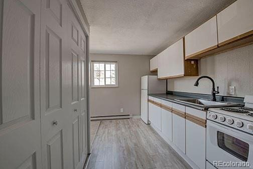 214 N Main St Unit 14, Breckenridge, CO 80424 - kitchen with white appliances, a sink, a textured ceiling, white cabinets, and baseboard heating