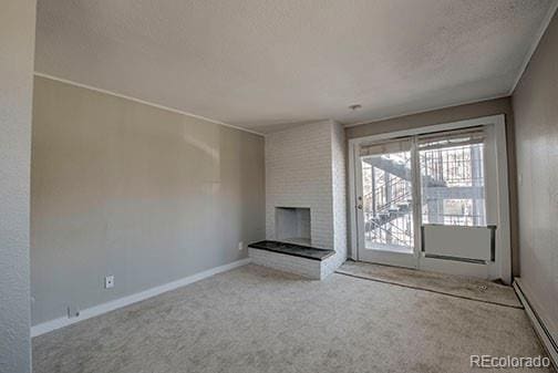 214 N Main St Unit 14, Breckenridge, CO 80424 - unfurnished living room with a fireplace, carpet, a textured ceiling, and baseboards