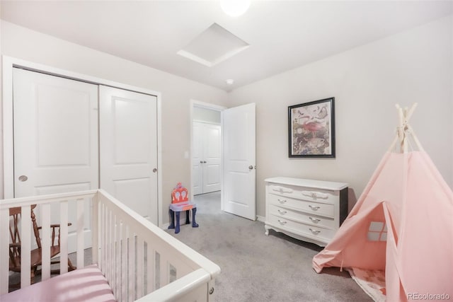 bedroom with a closet, a nursery area, and carpet flooring