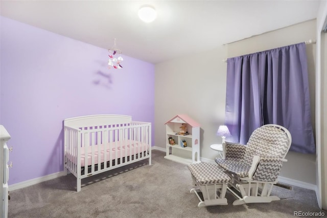carpeted bedroom with a nursery area and baseboards