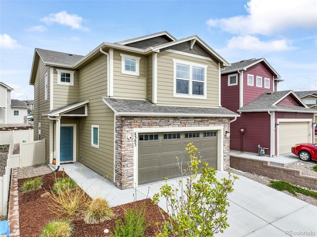craftsman inspired home with concrete driveway, fence, stone siding, and a garage