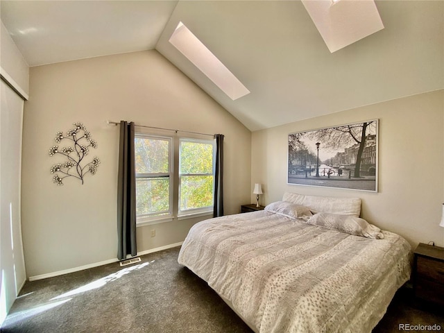 bedroom with lofted ceiling with skylight and dark colored carpet