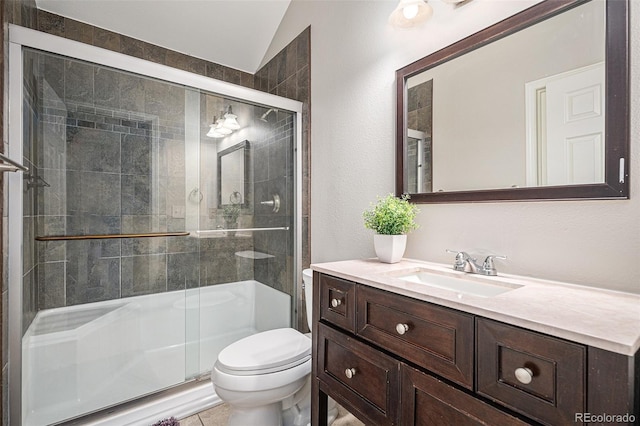 bathroom featuring vanity, toilet, vaulted ceiling, and an enclosed shower