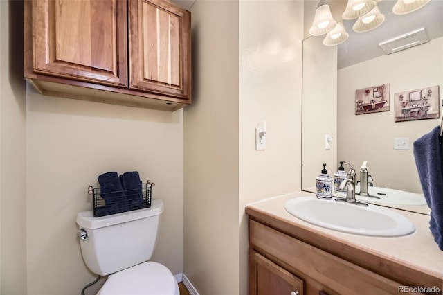 bathroom featuring vanity and toilet