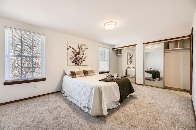 bedroom featuring multiple closets and carpet